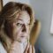 Photo by RDNE Stock project A woman applying a skincare product indoors, focusing on relaxation and self-care.